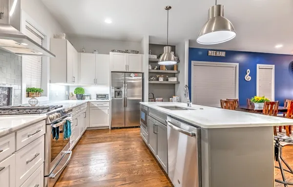 a kitchen with a dining table a sink and a chandelier