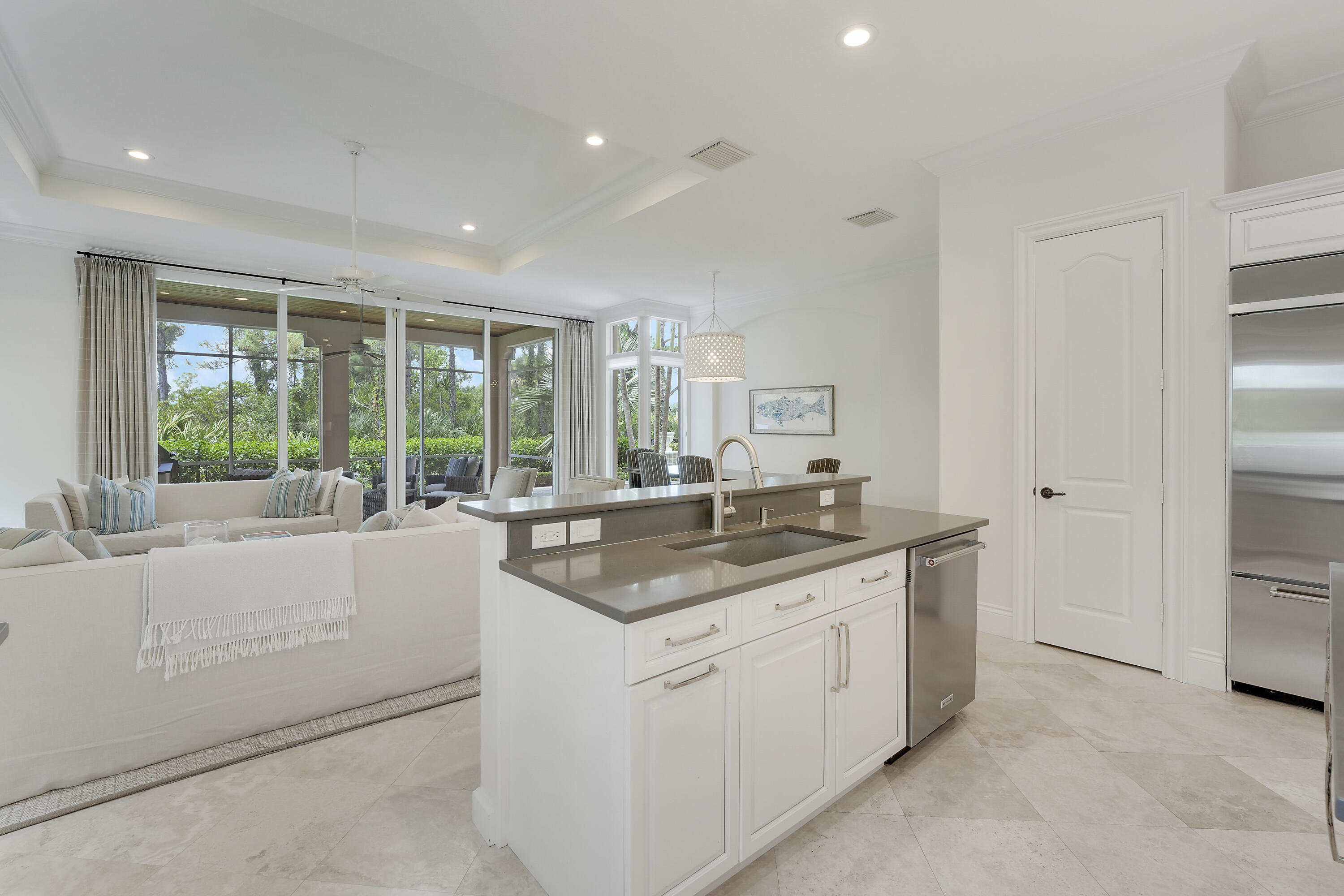 140 Tulip Tree Court Jupiter, FL 33458 - Photo 16 of 80 a kitchen with a sink and large window