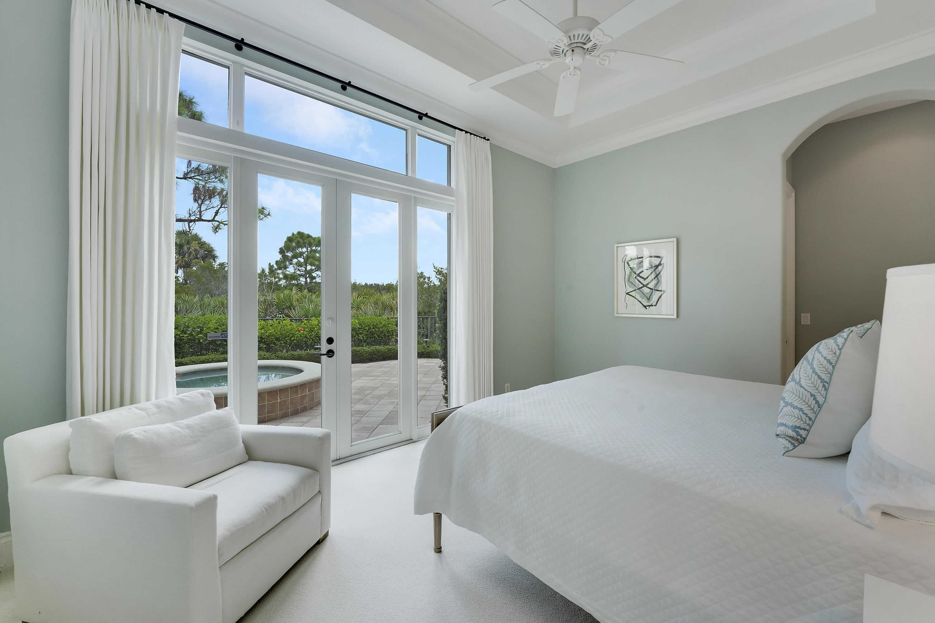 140 Tulip Tree Court Jupiter, FL 33458 - Photo 30 of 80 a bedroom with a bed and a large window