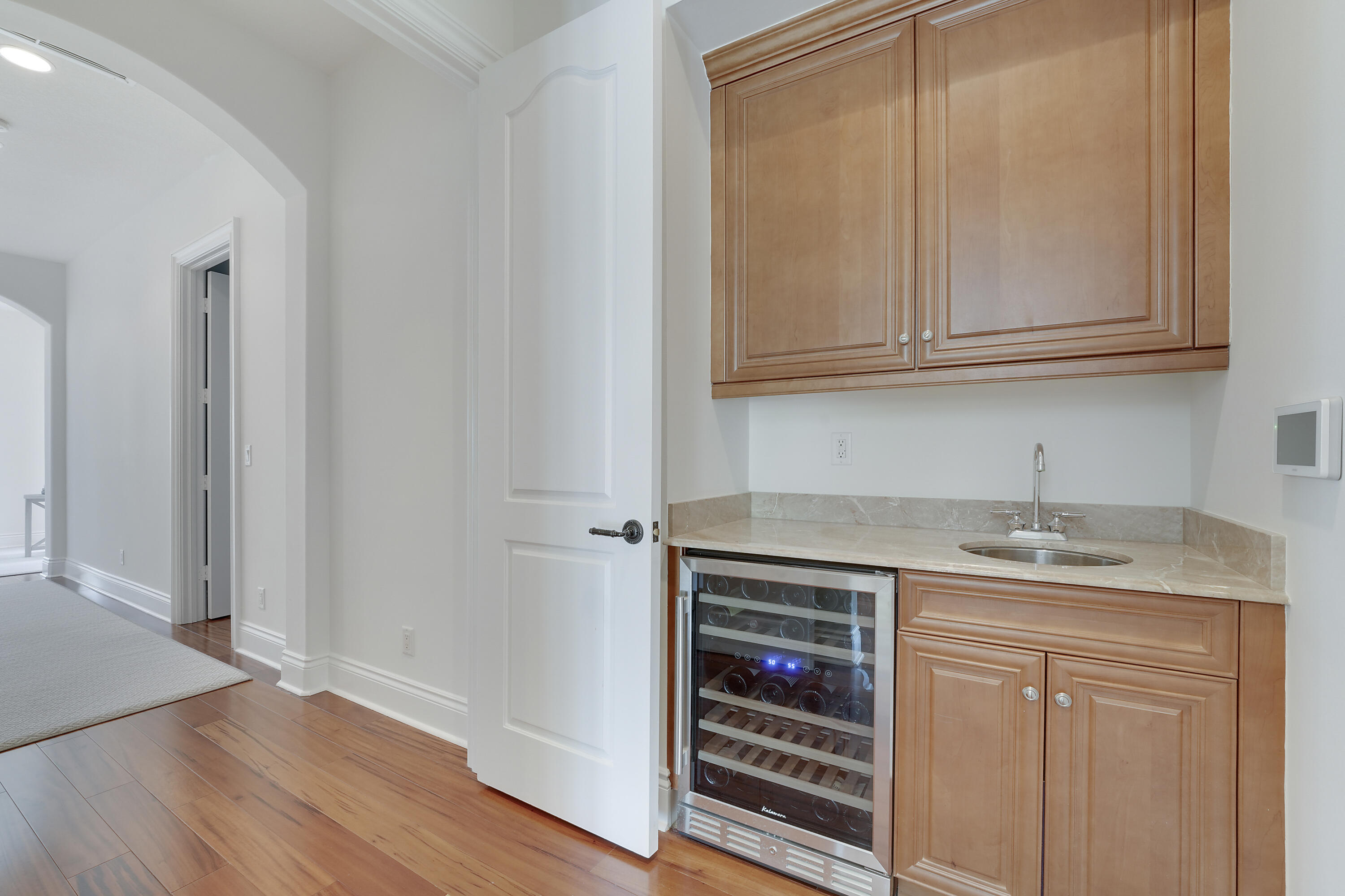 140 Tulip Tree Court Jupiter, FL 33458 - Photo 44 of 80 a kitchen with granite countertop a sink and dishwasher a stove with wooden floor