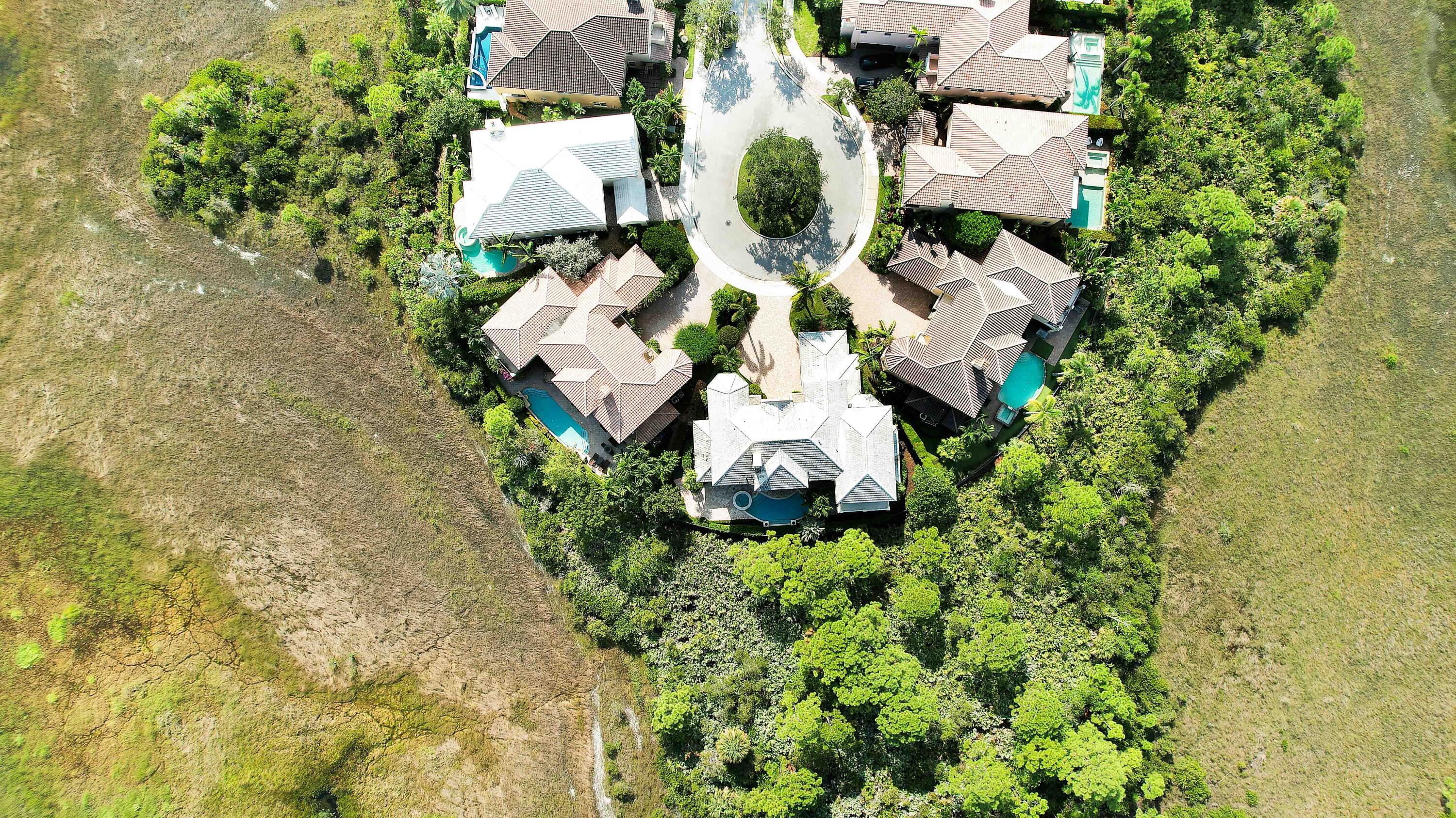 140 Tulip Tree Court Jupiter, FL 33458 - Photo 80 of 80 an aerial view of a house with a yard and garden