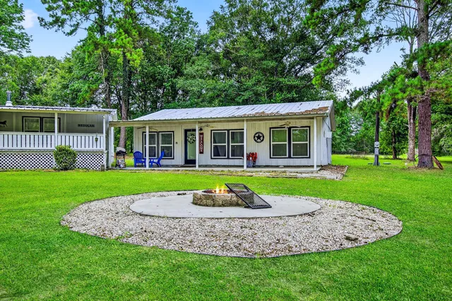 a view of an house with backyard space and garden