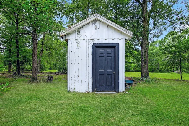 a view of a patio with a table chairs and a backyard