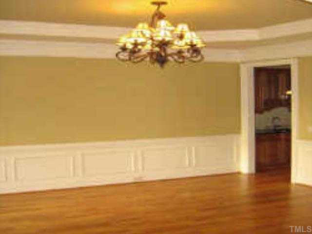 3226 Rain Forrest Way Raleigh, NC 27614 - Photo 2 of 12 The large formal Dining Room features wainscoting, a trey ceiling and a chandelier. You can see part of the Butler's Pantry that is located between the Dining Room and Kitchen.