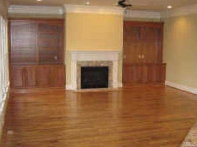 3226 Rain Forrest Way Raleigh, NC 27614 - Photo 6 of 12 The large Family Room with cherry built-ins and gas log fireplace overlooks the kitchen and the outside deck.