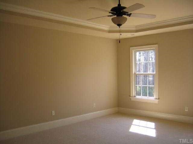 3226 Rain Forrest Way Raleigh, NC 27614 - Photo 8 of 12 The Owner's Suite bedroom features a trey ceiling w/ crown and 2 walk in closets!