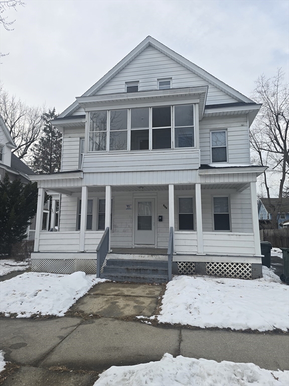 a view of a white house with large windows