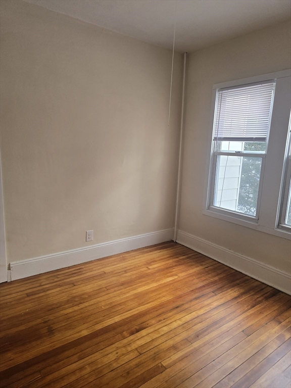 100 Albemarle Street, Unit 1 Springfield, MA 01109 - Photo 11 of 11 a view of an empty room with wooden floor and a window