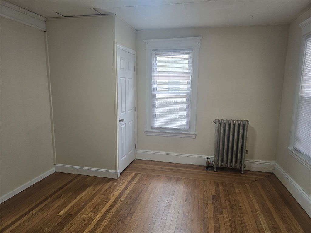 100 Albemarle Street, Unit 1 Springfield, MA 01109 - Photo 6 of 11 an empty room with wooden floor and windows