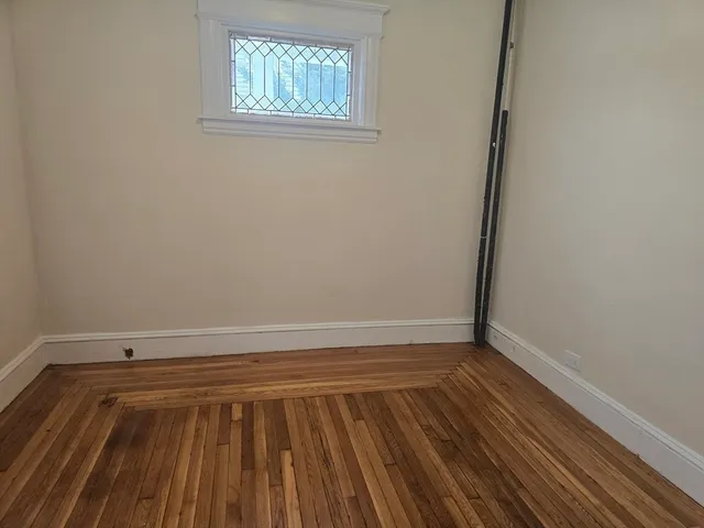 a view of a room with wooden floor