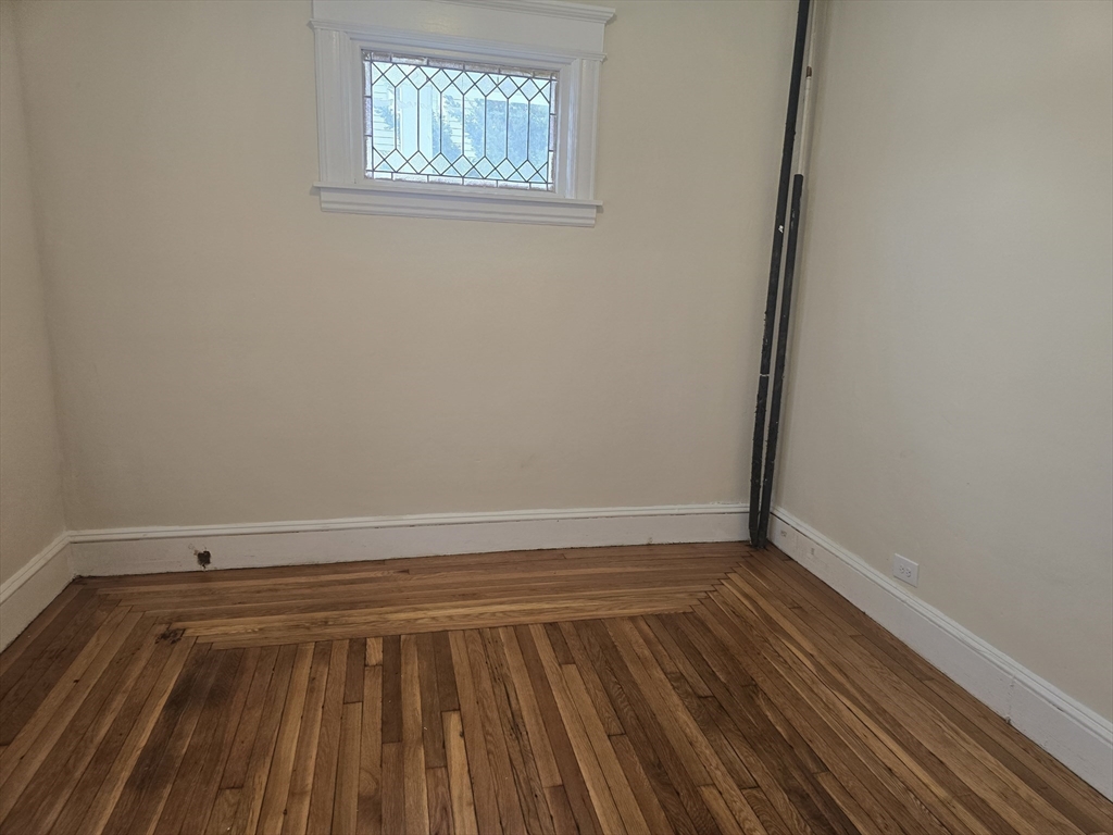 100 Albemarle Street, Unit 1 Springfield, MA 01109 - Photo 7 of 11 a view of an empty room with wooden floor and a window