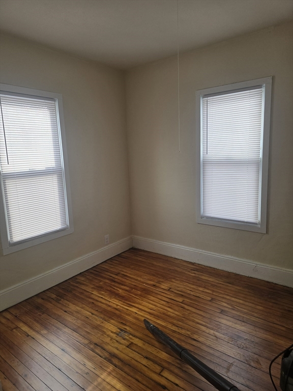 100 Albemarle Street, Unit 1 Springfield, MA 01109 - Photo 9 of 11 a view of an empty room with wooden floor and a window