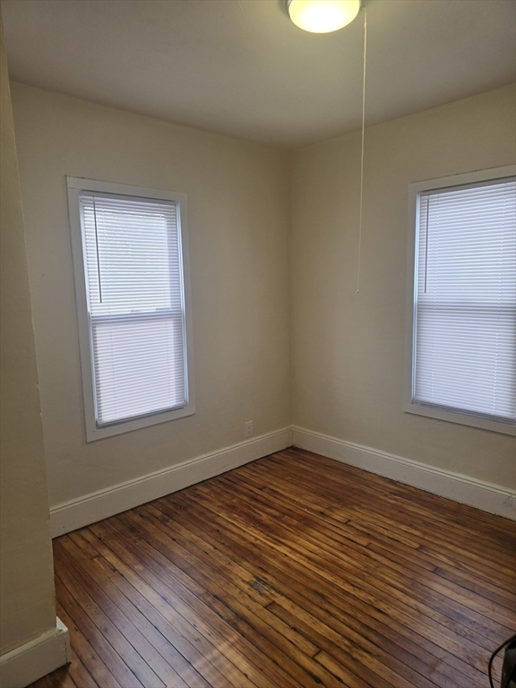 100 Albemarle Street, Unit 1 Springfield, MA 01109 - Photo 10 of 11 a view of an empty room with wooden floor and a window