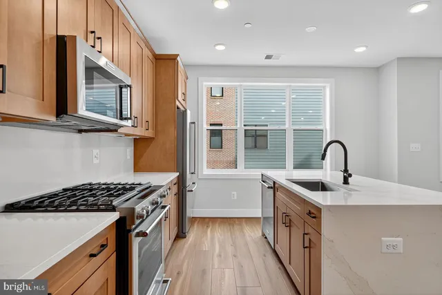 a kitchen with a sink and a stove top oven