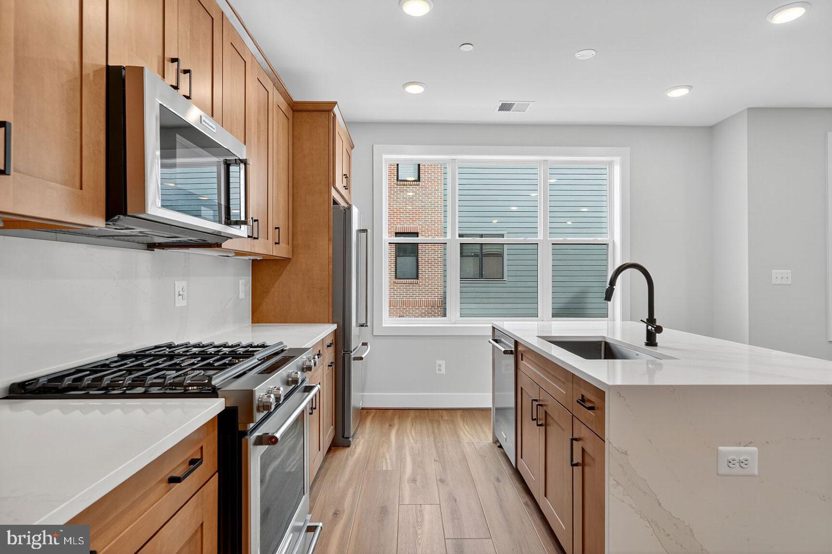 116 Pepperell Street Alexandria, VA 22304 - Photo 3 of 19 a kitchen with a sink and a stove top oven