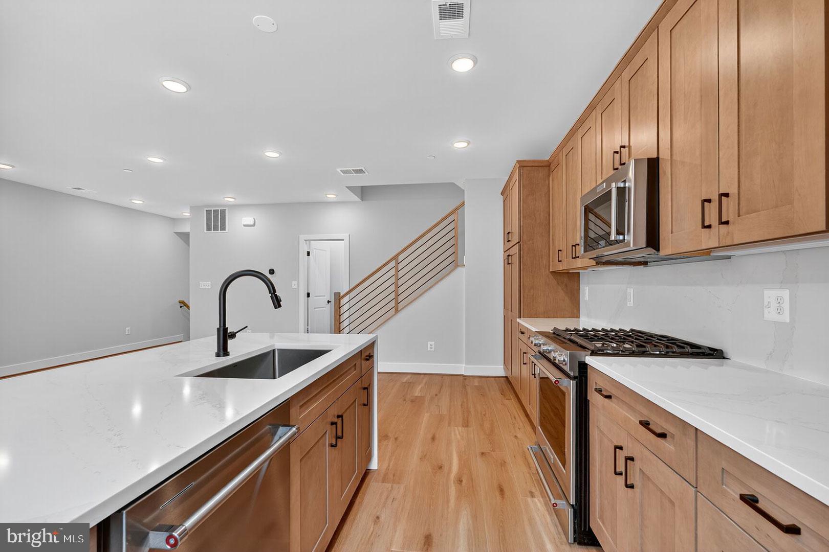 116 Pepperell Street Alexandria, VA 22304 - Photo 4 of 19 a kitchen with stainless steel appliances a sink stove and cabinets