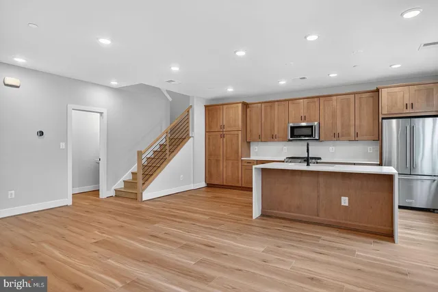 a view of kitchen with refrigerator microwave and wooden floor