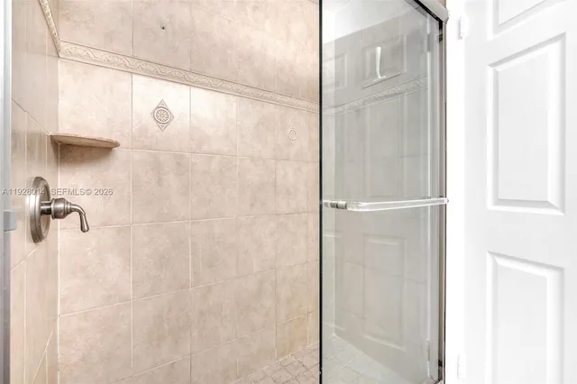 a bathroom with a glass shower door