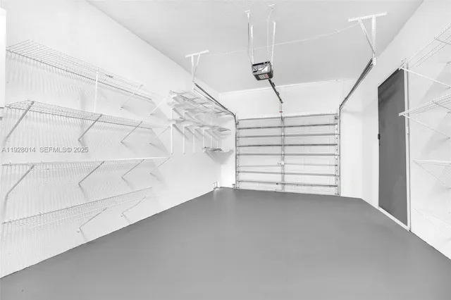 a view of empty room with stairs and white walls