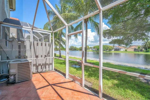 a backyard of a house with lake view and a potted plant