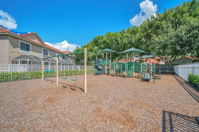 a view of a house with a backyard and a tree