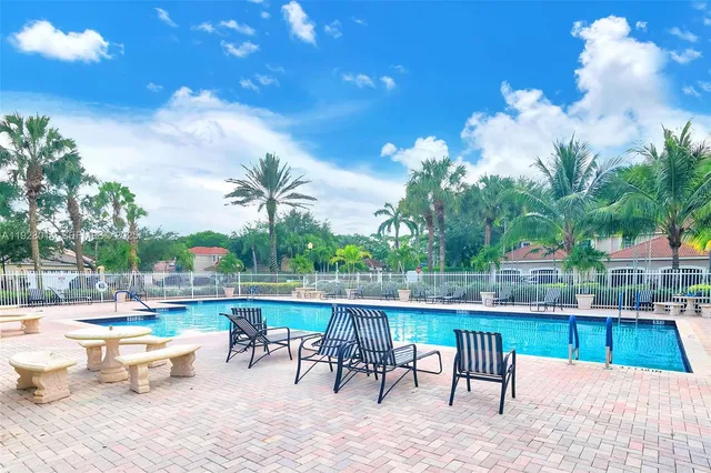 a view of a swimming pool with outdoor seating