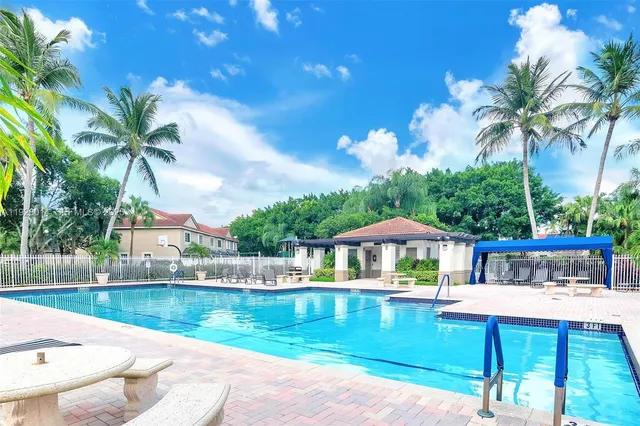 a view of swimming pool with outdoor seating and yard