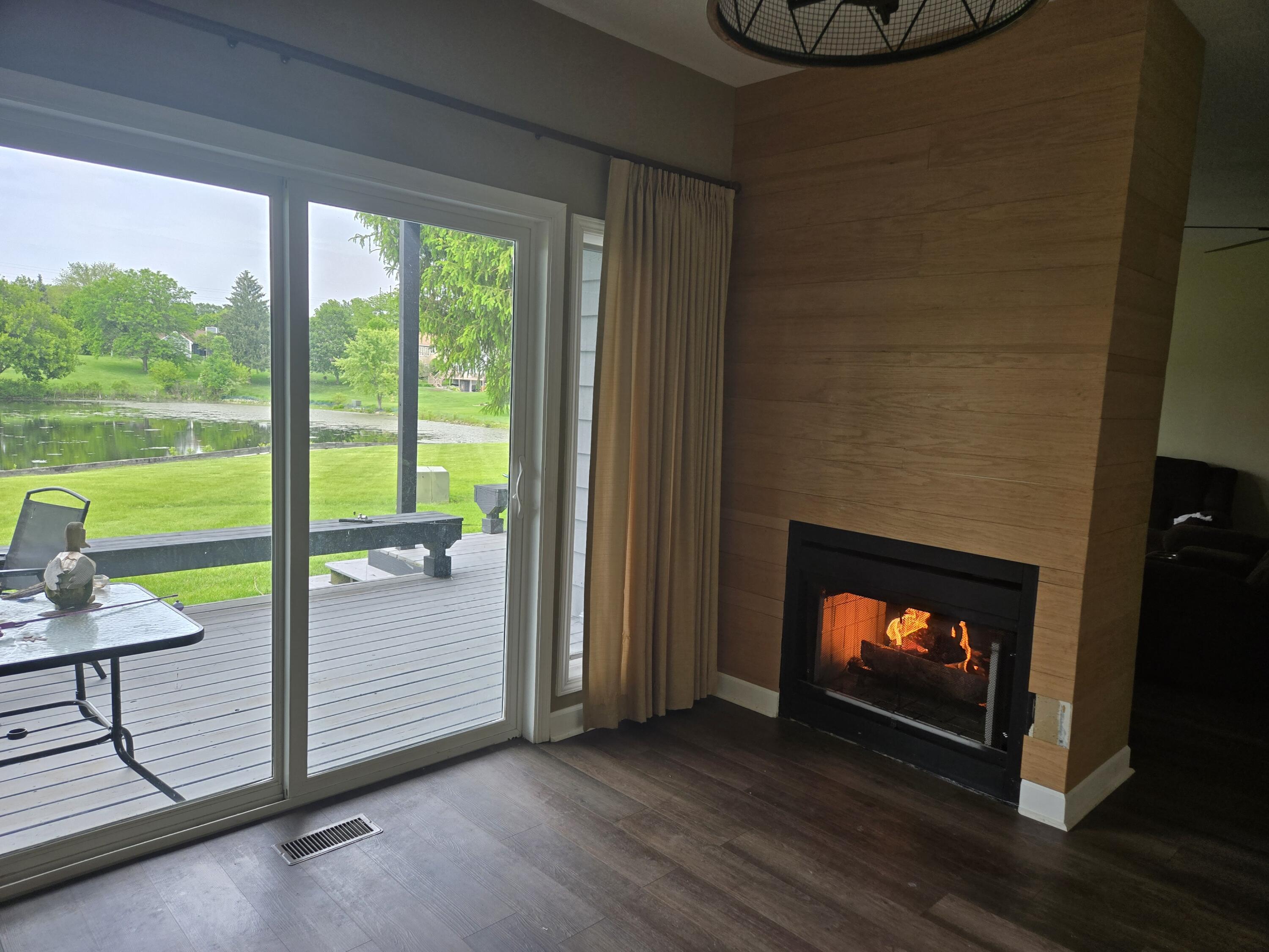 1300 Winding Ridge Lane, Unit C8 Valparaiso, IN 46383 - Photo 5 of 13 a living room with a fireplace and a floor to ceiling window