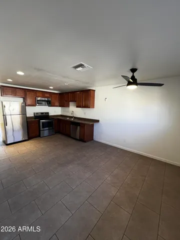 a room with furniture and view of kitchen