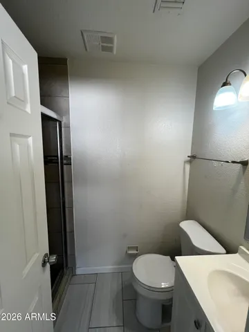 a white toilet sitting next to a bathroom sink