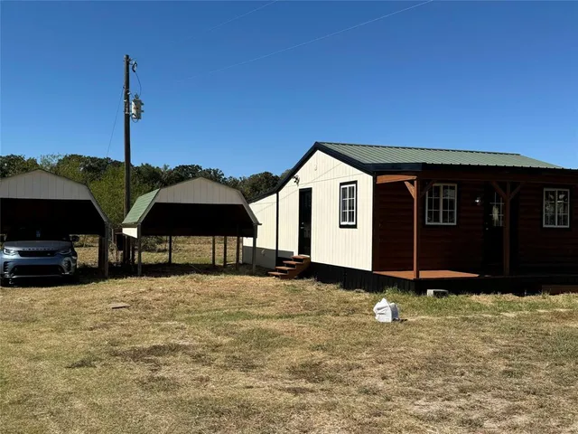 a view of a house with yard and furniture