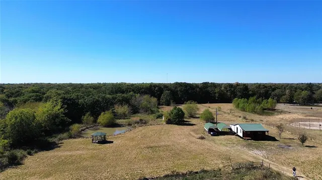 a view of a yard with a table and chairs