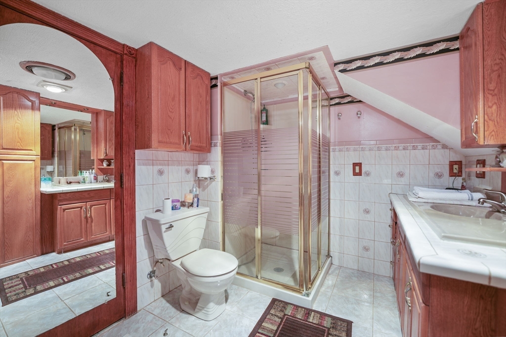 493 Peckham Street Fall River, MA 02721 - Photo 22 of 38 a bathroom with a sink toilet vanity and shower