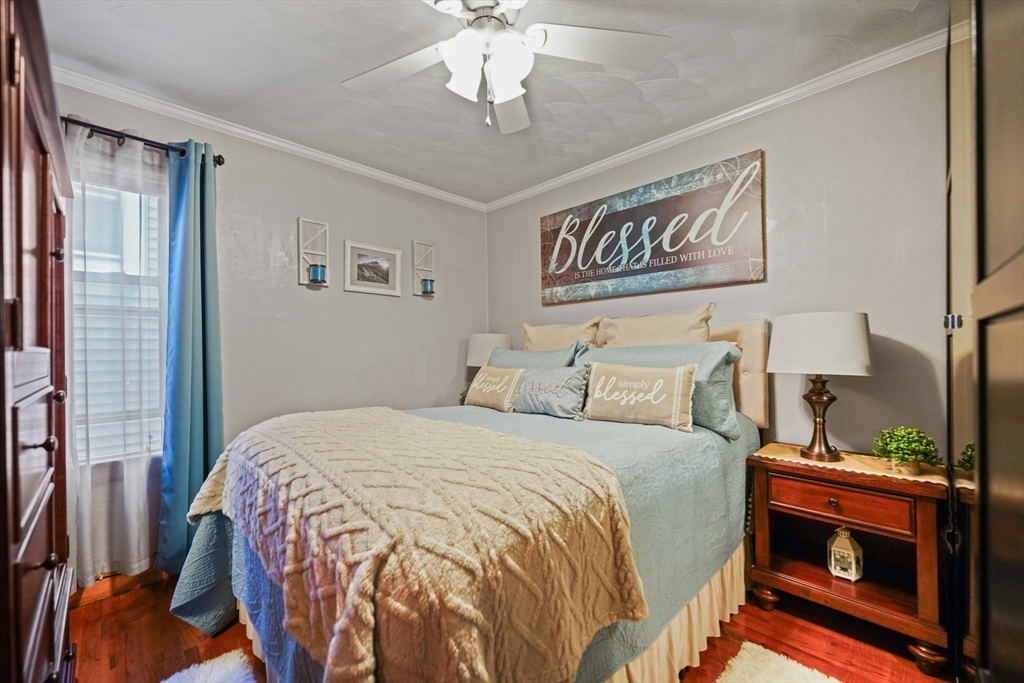 493 Peckham Street Fall River, MA 02721 - Photo 31 of 38 a bedroom with a bed and a fireplace