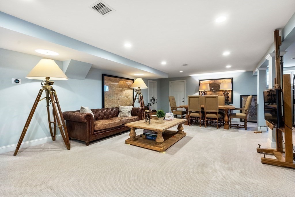 25 Byron Road Weston, MA 02493 - Photo 18 of 21 a living room with furniture gym equipment and a flat screen tv