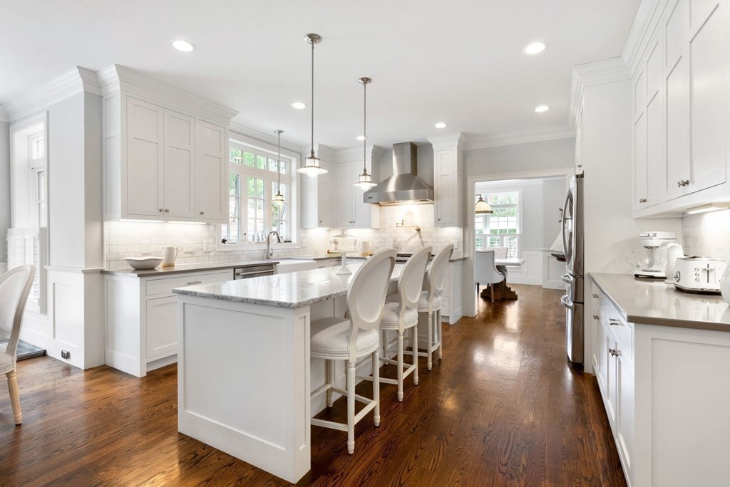 25 Byron Road Weston, MA 02493 - Photo 6 of 21 a kitchen with stainless steel appliances kitchen island granite countertop a stove a sink a refrigerator and white cabinets with wooden floor
