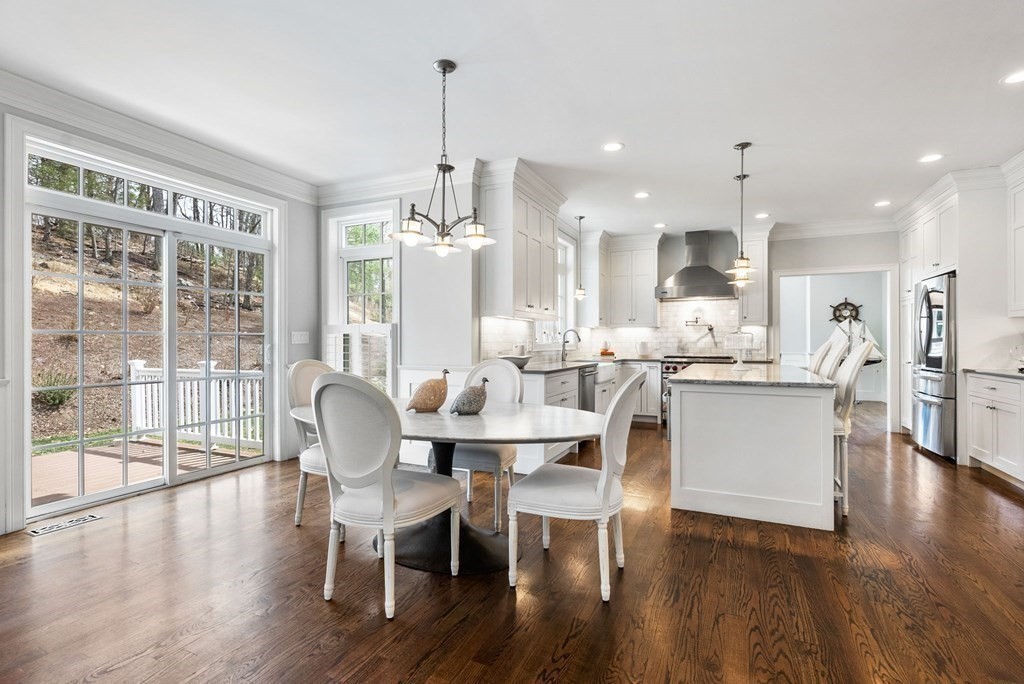 25 Byron Road Weston, MA 02493 - Photo 9 of 21 a dining room with stainless steel appliances kitchen island granite countertop a table chairs and a living room view