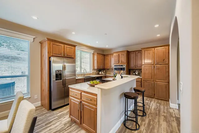 a kitchen with stainless steel appliances granite countertop a stove and cabinets