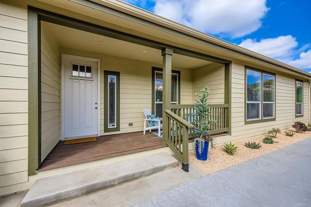 an outdoor view of a house with glass windows and door