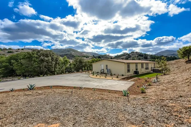 a big house with a big yard and large tree