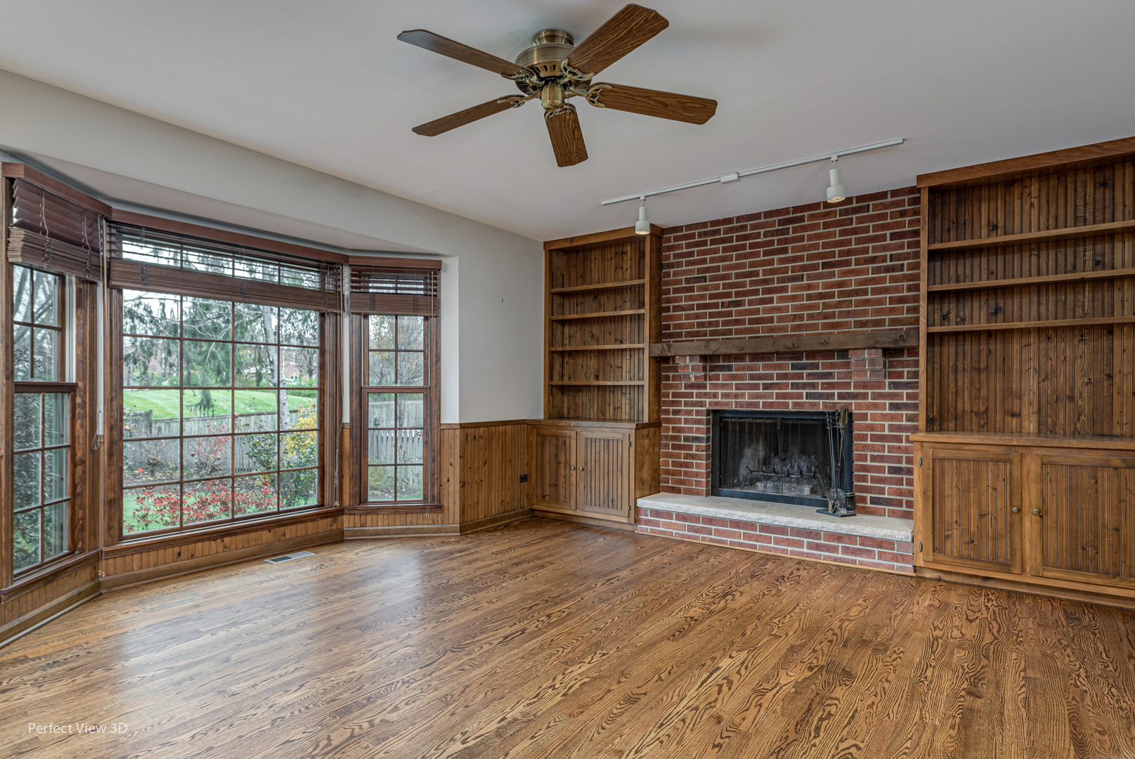1243 Redfield Road Naperville, IL 60563 - Photo 9 of 45 a view of an empty room with a fireplace and a window