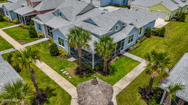 an aerial view of a house with a yard