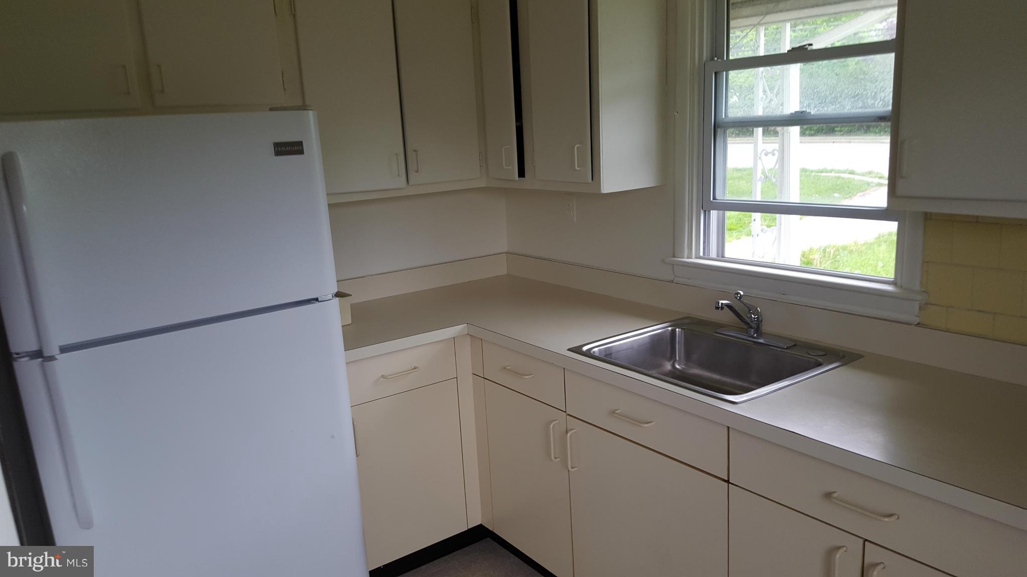 8320 Liberty Road Baltimore, MD 21244 - Photo 4 of 13 a kitchen with a refrigerator and a sink