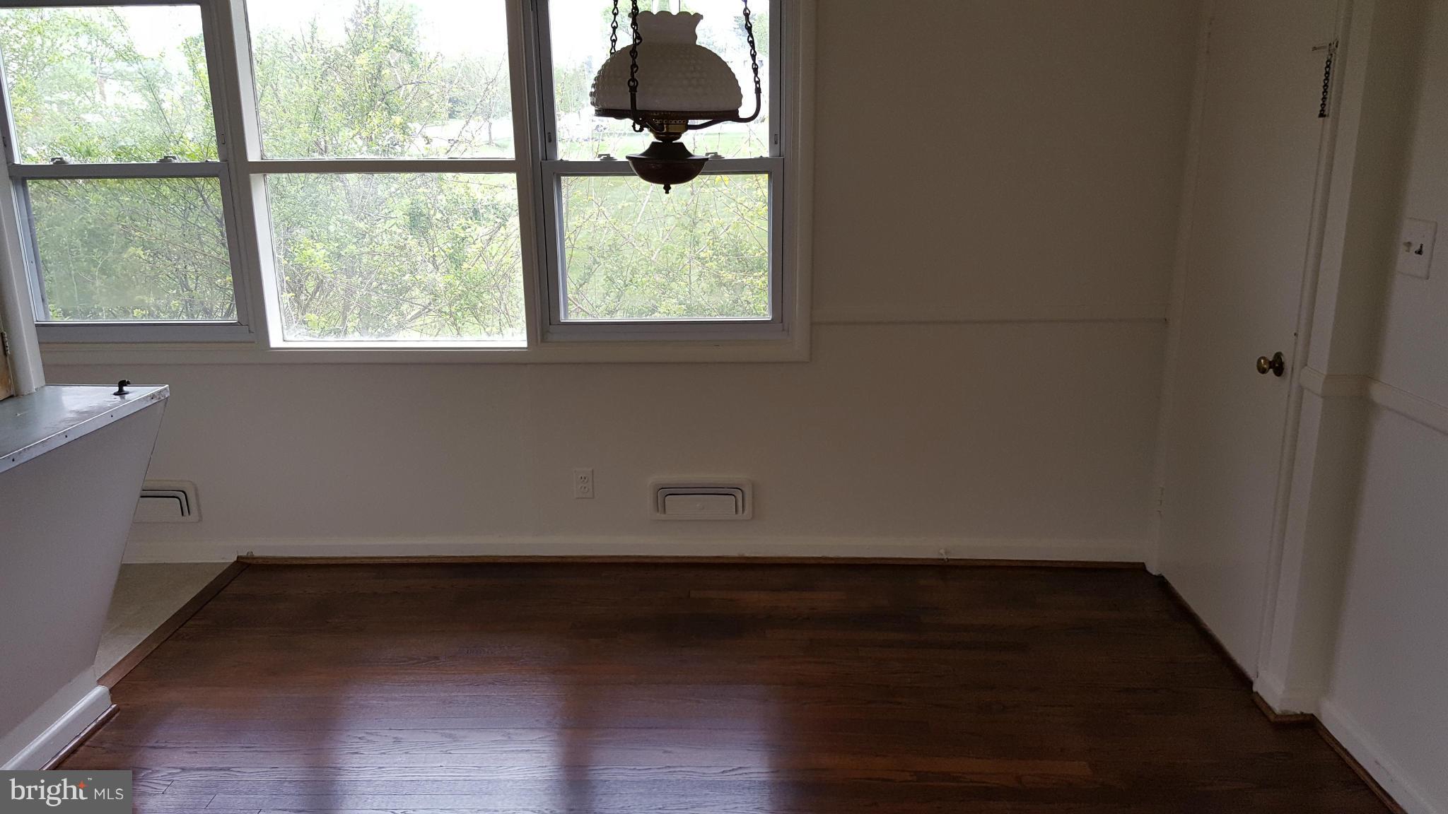 8320 Liberty Road Baltimore, MD 21244 - Photo 8 of 13 an empty room with wooden floor and windows