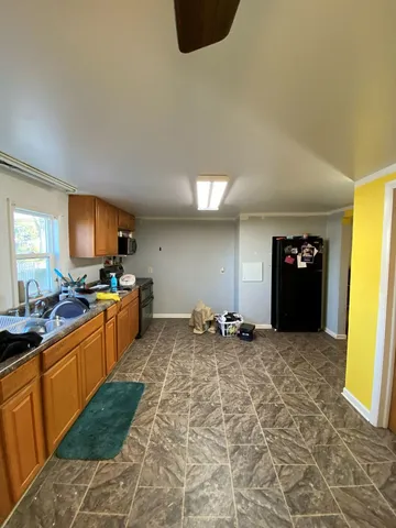 a large kitchen with lot of cabinets and appliances