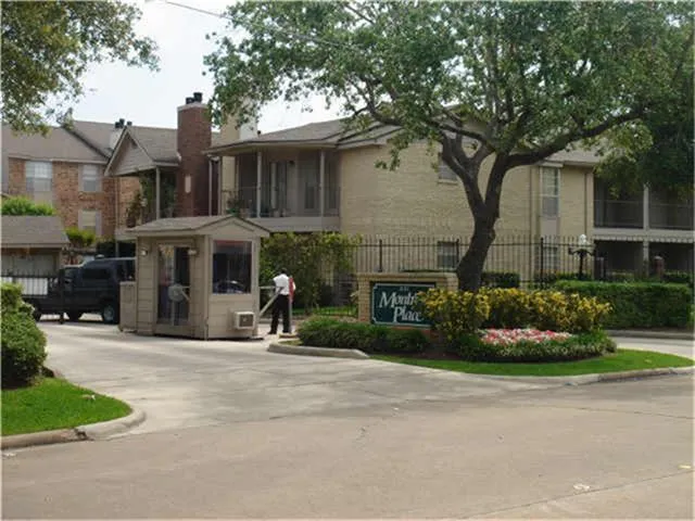 a front view of a house with a yard and potted plants