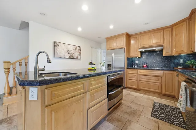 a spacious bathroom with a tub sink and a mirror