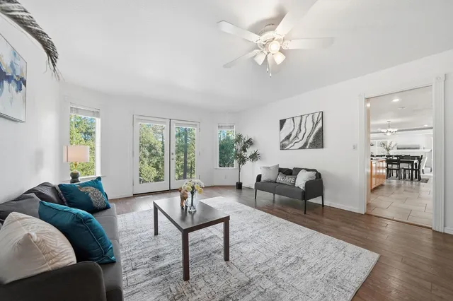 a view of a workspace with furniture and wooden floor