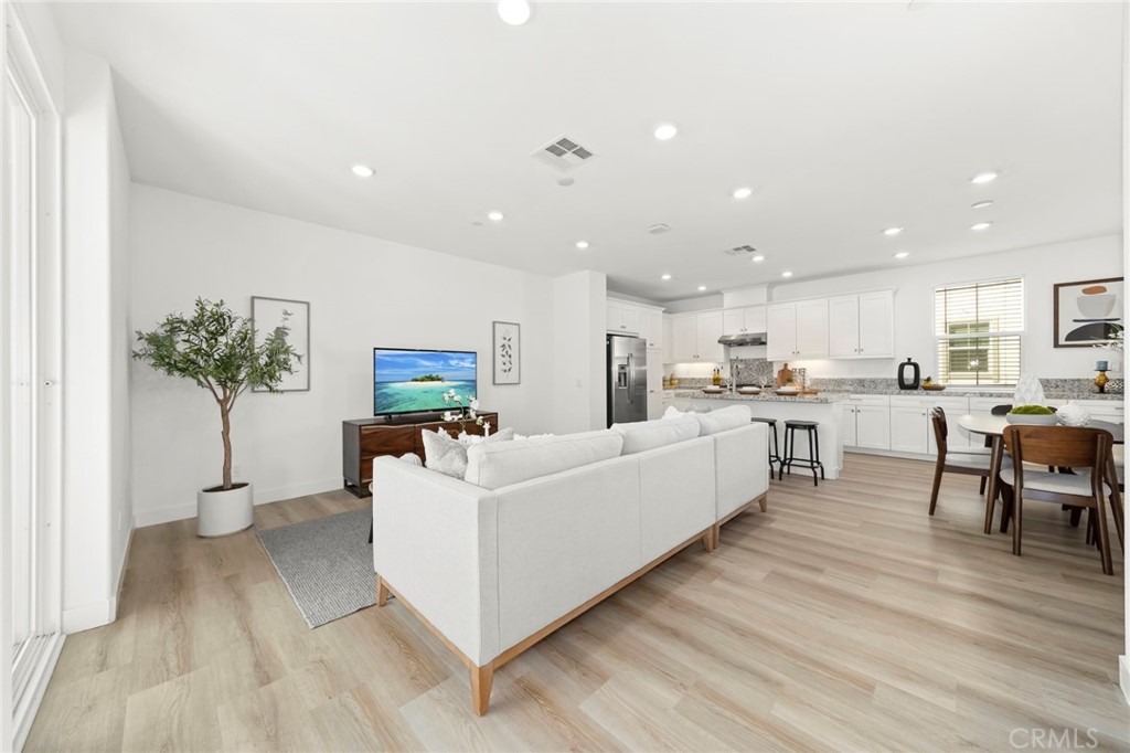 1533 St Simon Circle, Unit B Alhambra, CA 91803 - Photo 6 of 27 a living room with furniture and a kitchen view with wooden floor
