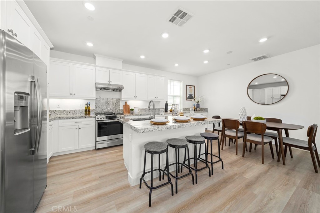 1533 St Simon Circle, Unit B Alhambra, CA 91803 - Photo 9 of 27 a large kitchen with a table and chairs